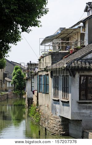 Weathered and old buildings lining the water canals in Luzhi Town in Jiangsu province China.