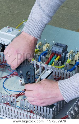 man cleans the wire for assembling electric Cabinet