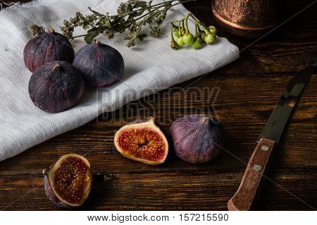 Ripe and juicy figs lying on rustic table with other things