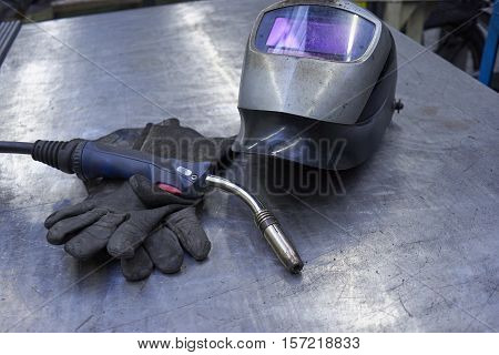A Couple Of Welder Equipment On A Steel Plate