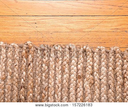 Jute pile hand woven beige area rug on old hardwood floor