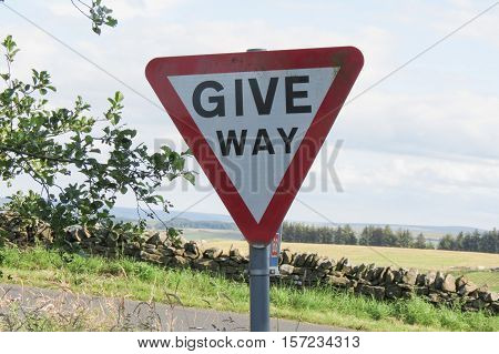 Regulatory signs Give way traffic sign in the British countryside