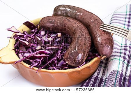 Homemade blood sausage with cabbage on a white background. Studio Photo