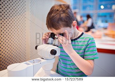Little Child Boy Looking Through Microscope