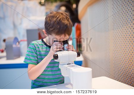 Little Child Boy Looking Through Microscope