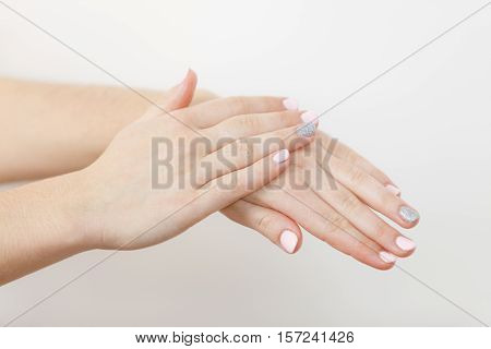 Woman Taking Care Of Her Dry Hands Applying Cream.