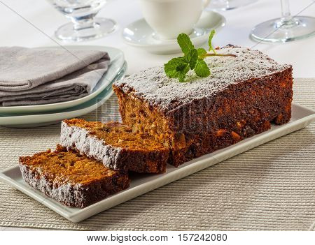Ginger cake with spices nuts and podered sugar.