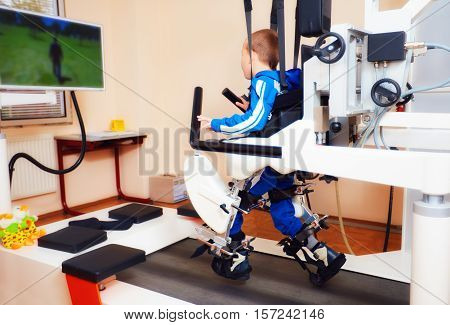 Young Boy Passes Robotic Gait Therapy In Rehabilitation Center