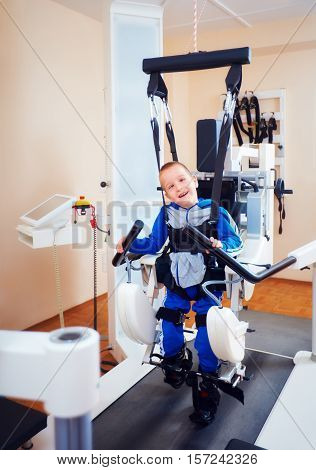Young Boy Passes Robotic Gait Therapy In Rehabilitation Center