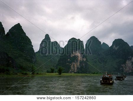 Two ferries carry passengers on the Li River, between Yangshuo and Guilin, China, circa 1987.