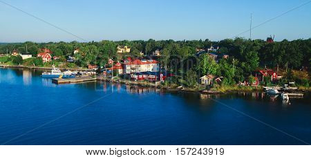 Beautiful super wide-angle aerial view of Stockholm archipelago skerries and suburbs with classic sweden scandinavian designed cottage houses from massive ferryboat