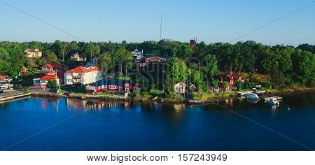 Beautiful super wide-angle aerial view of Stockholm archipelago skerries and suburbs with classic sweden scandinavian designed cottage houses from massive ferryboat