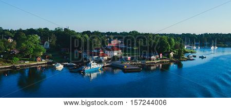 Beautiful super wide-angle aerial view of Stockholm archipelago skerries and suburbs with classic sweden scandinavian designed cottage houses from massive ferryboat