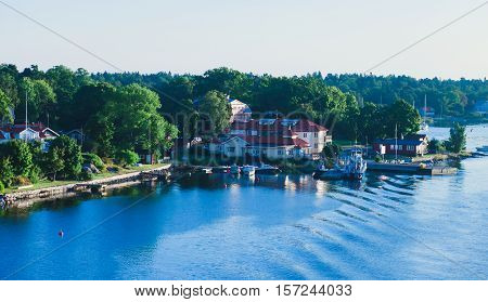 Beautiful super wide-angle aerial view of Stockholm archipelago skerries and suburbs with classic sweden scandinavian designed cottage houses from massive ferryboat