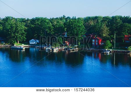 Beautiful super wide-angle aerial view of Stockholm archipelago skerries and suburbs with classic sweden scandinavian designed cottage houses from massive ferryboat