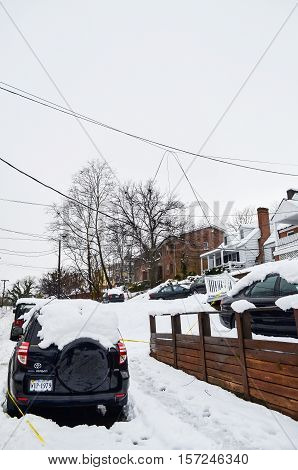 Charlottesville, USA - March 6, 2013: JPA street with a lot of snow piled on cars after and broken telephone lines winter storm