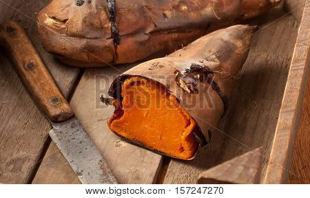 Oven baked sweet potatoes on vintage wood.
