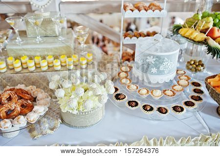 Wedding Cakes And Candies On Reception Table.