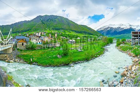 The winding fast flowing Mestiachala river surrounded by mountains Mestia Upper Svaneti Georgia.