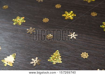 Christmas shiny sequins on a wooden background