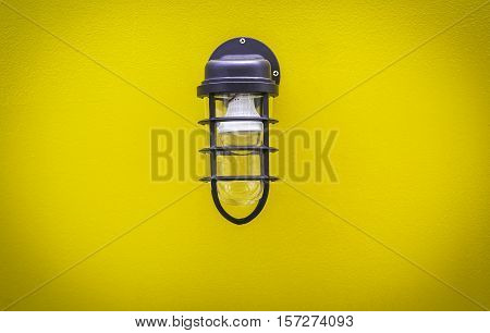 Classic lamp on surface yellow wall background
