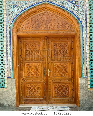 Old wooden door to the mosque hand-crafted. Ali bin Abi Taleb Mosque in old city Deira Dubai. The creek is divides the city into two main sections Deira and Bur Dubai old downtown of Dubai.