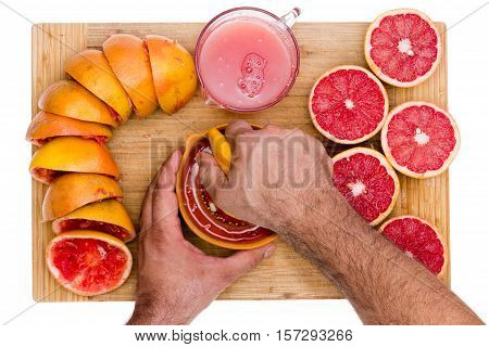 Hands Of A Man Squeezing Fresh Ruby Grapefruit