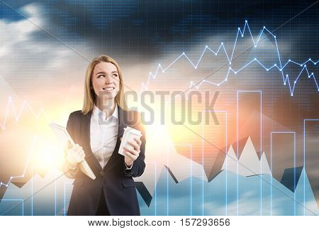 Smiling blond woman is holding her coffee and notebook. Graphs are seen in the background. Toned image. Double exposure