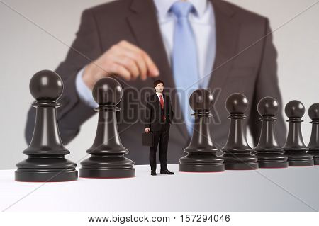 Close up of a man playing chess. One of the pawns is a businessman. Concept of strategy and management