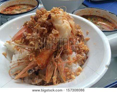 Close up stir fry garlic pepper prawn with  mushroom tomyum soup background