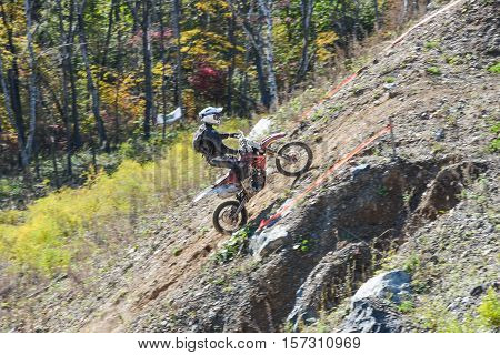 VLADIVOSTOK, RUSSIA - OCTOBER 10: competition On the edge 2016 Hard Enduro Rally with a KTM motorcycle. The hardest enduro rally in the world. October 10, 2016 in Vladivostok, Russia