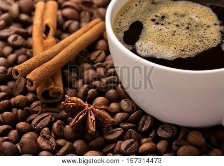 Coffee in beans with cinnamon bark and anise