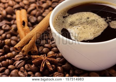 Coffee in beans with cinnamon bark and anise