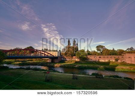 Urban landscape of the Warta river the bridge and the towers of the cathedral in Poznan