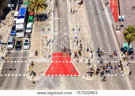 Barcelona, Spain - May 27, 2016: people crossing the street. Passeig de Colom, Barcelona