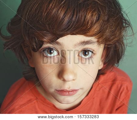 preteen handsome boy expressive close up serious portrait with big eyes