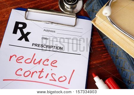 Prescription form with words reduce cortisol. Medical concept.