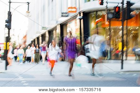 Blurred image of walking people. Londoners and tourists walking in Oxford street, one of the main shopping destination of London