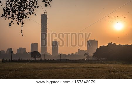 Kolkata cityscape at sunrise on a misty winter morning. Photograph taken from Kolkata Maidan area.