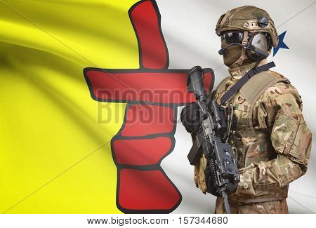 Soldier In Helmet Holding Machine Gun With Canadian Province Flag On Background Series - Nunavut