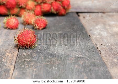 rambutan sweet fruit fresh on wood background :Select focus with shallow depth of field.
