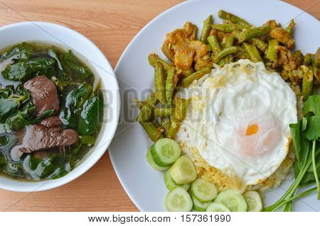 spicy stir fried yard long bean with fat pork curry topping egg and boiled pork blood soup