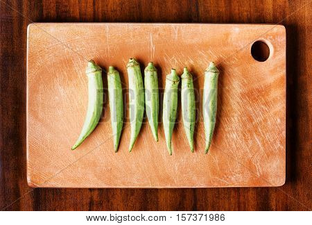 Green Seed Pods Okra On A Wooden Board. Healthy Popular Food