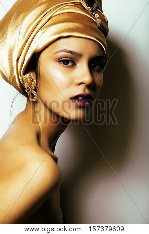 beauty african woman in shawl on head, very elegant look with gold jewelry close up  dark afro asian