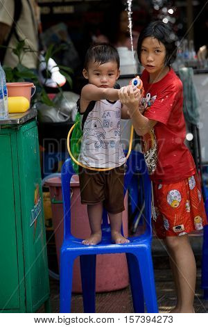 Bangkok, Thailand - April 13, 2008 : 
Children play with water guns during Songkran, the Thai New Year's festival.