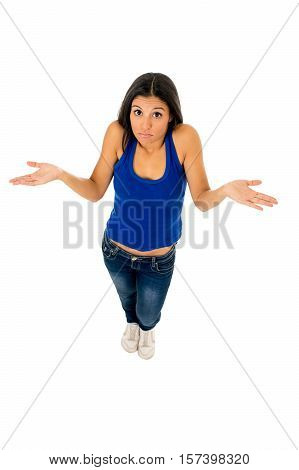 young attractive hispanic woman in casual top and jeans shrinking shoulders open arms wondering confused in doubt isolated on white background