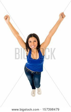 young happy attractive hispanic woman in casual top and jeans doing victory sign posing excited and cheerful isolated on white background