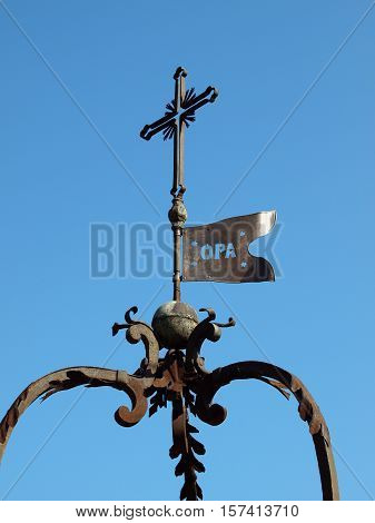 old metal cross against the sky in Tuscany