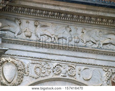 Siena - beautifully decorated frieze on the façade of Palazzo Publicco