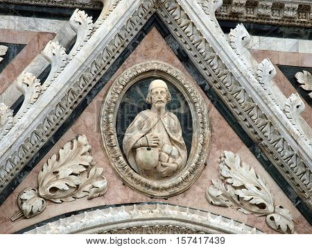 Architectural details of Duomo facade - SienaTuscanyItaly. The Duomo of Siena which was built in the 12th and 13th centuries is one of the prettiest churches in Gothic style in Italy